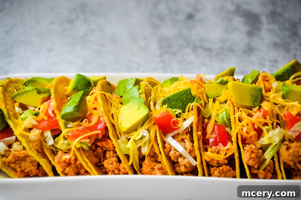 Easy Instant Pot Ground Turkey Tacos 2 A beautifully arranged spread of Instant Pot Ground Turkey Tacos ingredients, including fresh ground turkey, vibrant spices like cumin and chili powder, garlic cloves, white onion, tomato sauce, and crunchy taco shells. The scene suggests a wholesome and exciting cooking adventure.