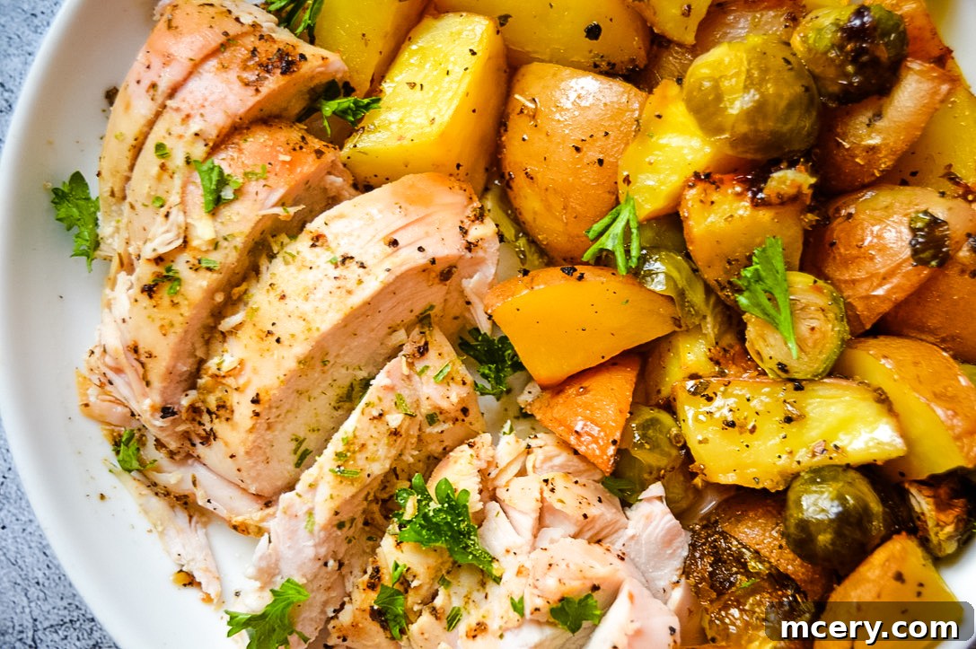 Effortless Sheet Pan Chicken and Potatoes 5 A close-up of a rustic wooden board with a selection of fresh ingredients for roasted chicken and potatoes. It includes raw chicken pieces, whole russet potatoes, green Brussels sprouts, and small bowls of avocado oil and various seasonings like garlic powder, onion salt, oregano, salt, and pepper. A sprig of fresh parsley completes the arrangement, showcasing the clean and simple components of the recipe.