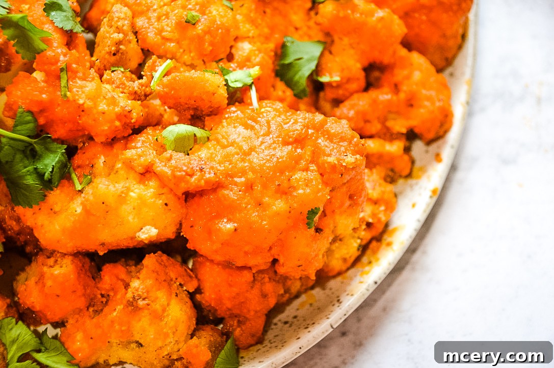 A vibrant close-up of the Buffalo Cauliflower Bites and Avocado Dip, showcasing the rich colors and inviting textures of the healthy appetizer.