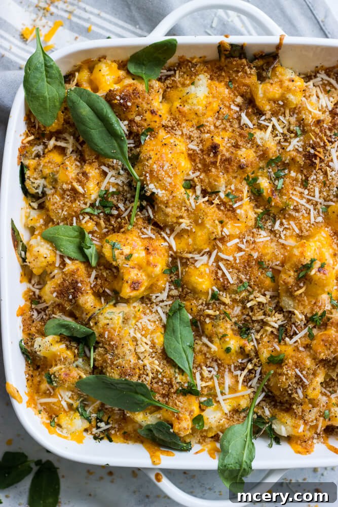 Close-up of creamy cauliflower spinach recipe in a baking dish, ready to be served.