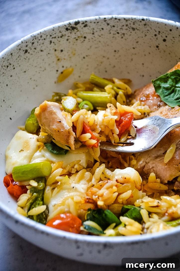 One-Pan Caprese Chicken Orzo Delight 3 Caprese Chicken and Orzo Skillet, close-up with melted mozzarella