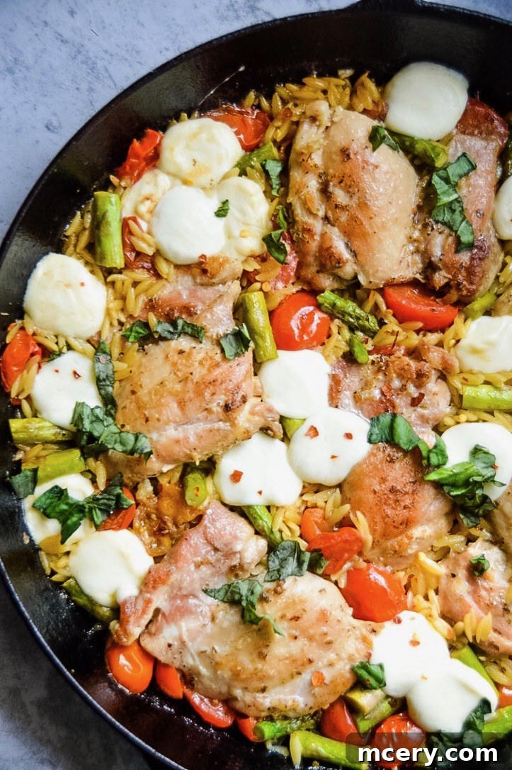 Caprese Chicken and Orzo Skillet, garnished with fresh basil