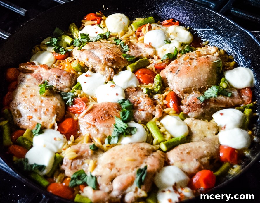 One-Pan Caprese Chicken Orzo Delight 7 Caprese Chicken and Orzo Skillet, overhead shot on a wooden table