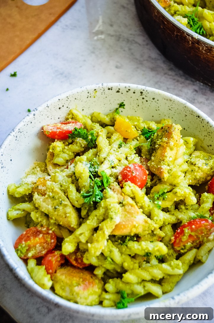 Emerald Pesto Chicken Pasta 4 Close-up shot of cooked chicken breast pieces, seasoned and golden brown in a skillet.