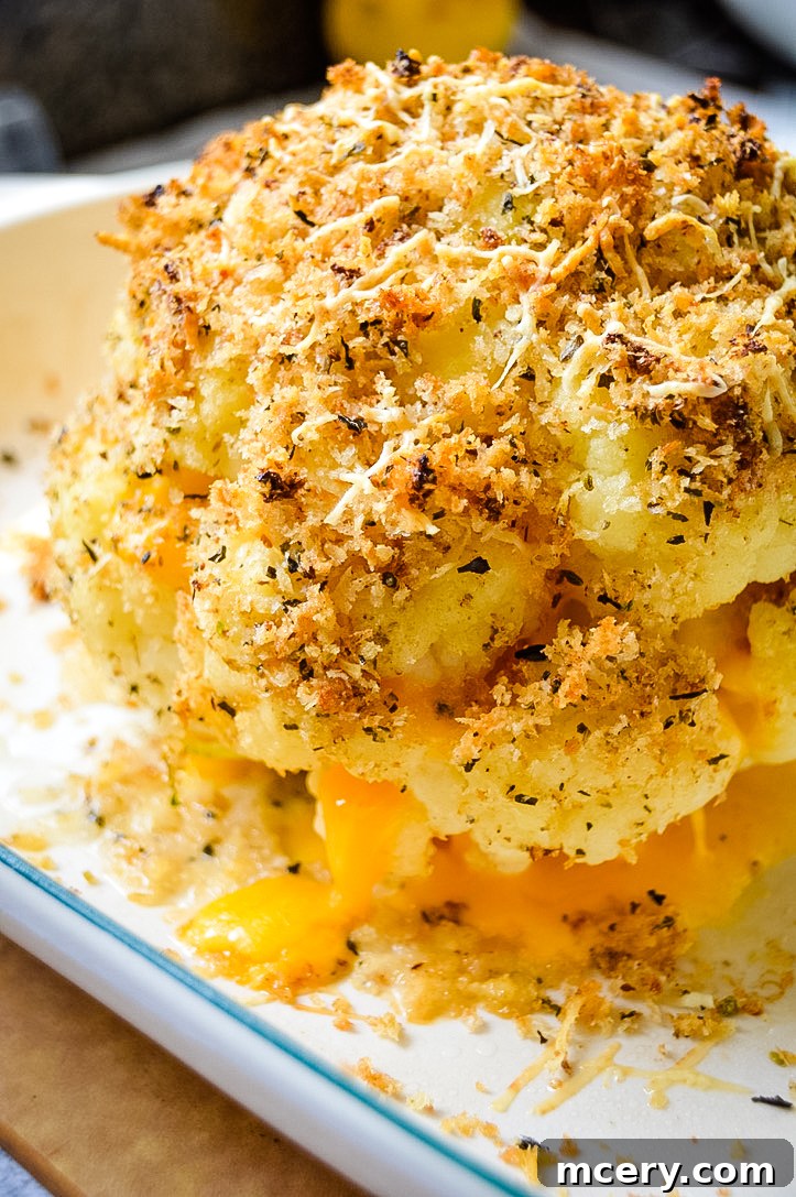 Golden Cheddar Stuffed Cauliflower 2 Golden-baked cheddar cheese stuffed cauliflower, presented as a whole head, glistening with a buttery, garlicky Panko crust. Perfect for a hearty side or a delicious vegetarian main dish.