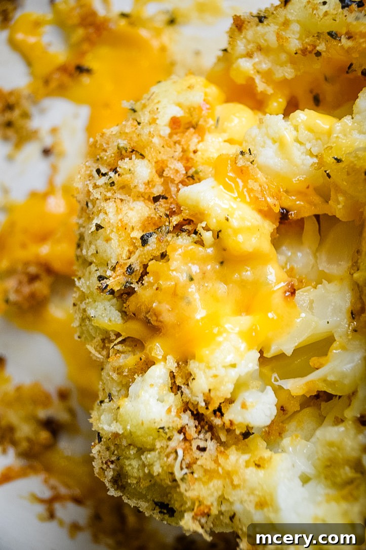 Golden Cheddar Stuffed Cauliflower 4 Another perspective of the whole cheddar cheese stuffed cauliflower, showcasing its beautifully baked exterior and the promise of a flavorful interior.