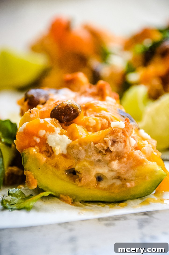 Cheesy Fiesta Zucchini Boats 4 A vibrant close-up of the prepared Southwest Zucchini Boat filling, featuring a rich mix of ground meat, corn, black beans, diced tomatoes, and green chilies, seasoned to perfection and ready to be scooped into zucchini shells.