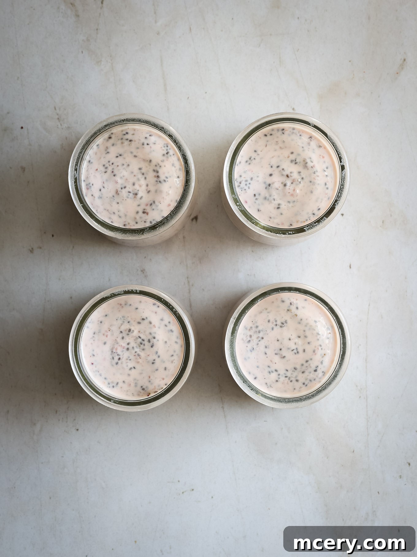 Delightful Strawberry Chia Pudding 7 Chia pudding in glass jars, covered and ready for refrigeration.