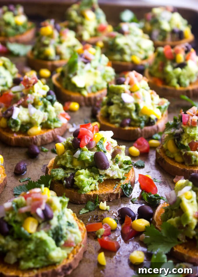 Golden Sweet Potato Guac Bites 3 Close-up of sweet potato bites topped with guacamole, showcasing their vibrant colors and textures.