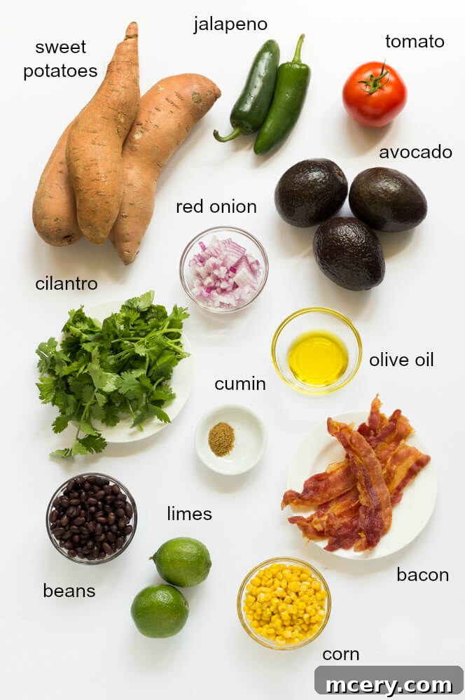 Golden Sweet Potato Guac Bites 4 A collection of fresh ingredients laid out, including sweet potatoes, avocados, corn, black beans, red onion, tomatoes, and cilantro, ready for making sweet potato bites.