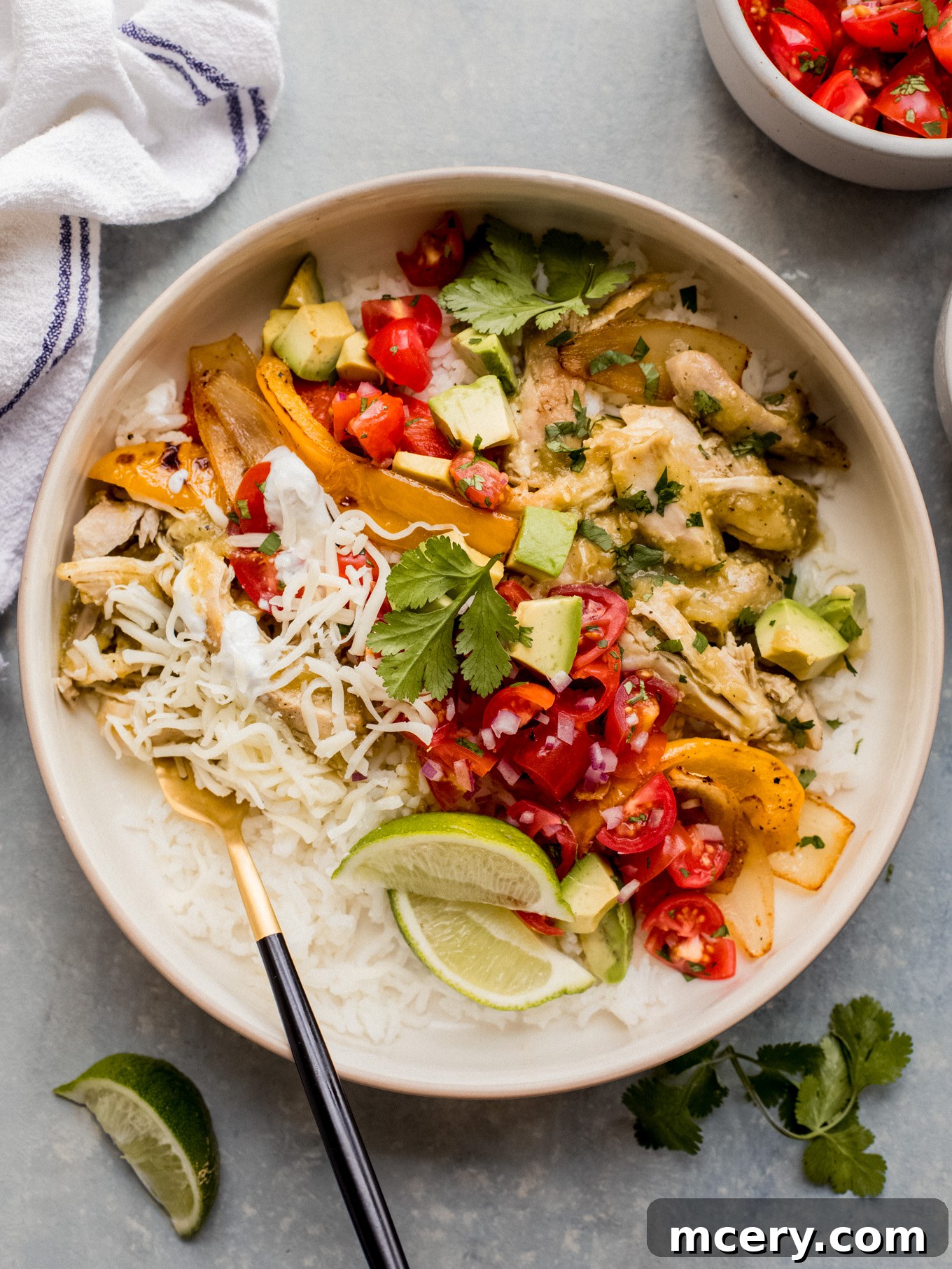 Sizzling Chicken Fajita Bowl 2 Delicious chicken fajita bowl generously topped with avocado, salsa, cilantro, and creamy dressing over rice.