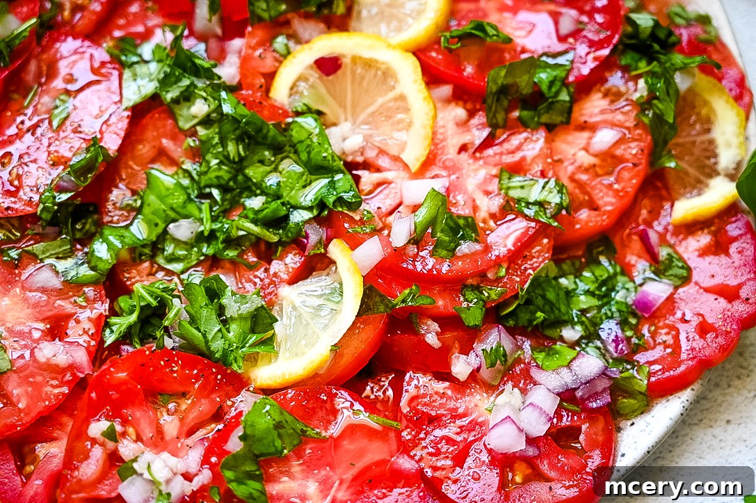 Kay's Zesty Marinated Tomatoes 3 Close-up of Marinated Tomatoes arranged on a plate with fresh basil