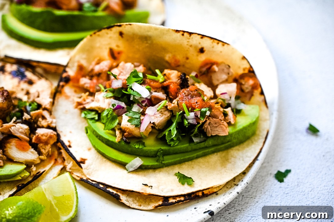 Variety of grilled chicken street tacos with different toppings arranged on a serving platter.