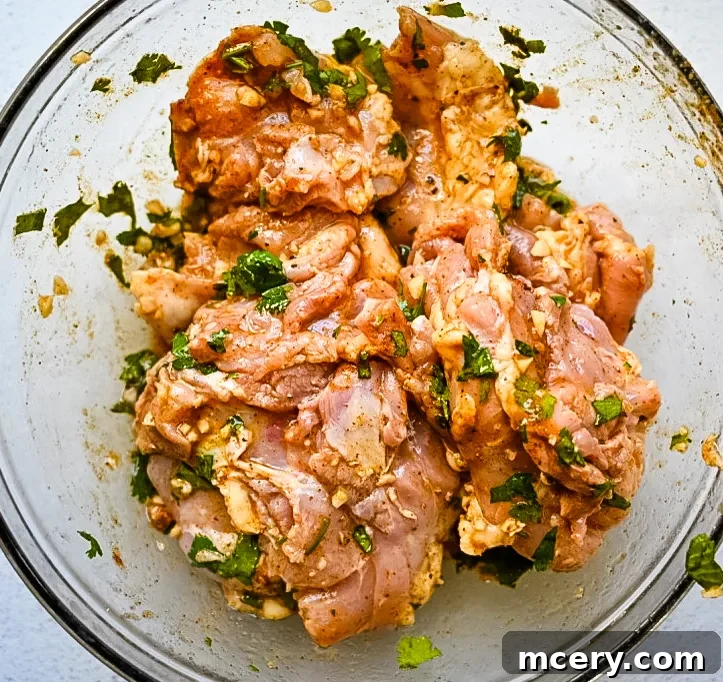 Grilling marinated chicken on a hot grill.