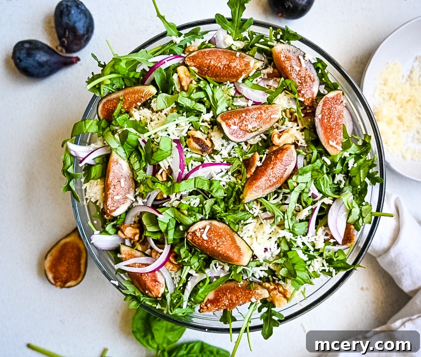 Vibrant Fig and Arugula Medley 2 A beautifully presented Fresh Fig and Arugula Salad with whole and halved figs, scattered walnuts, and a light dressing.