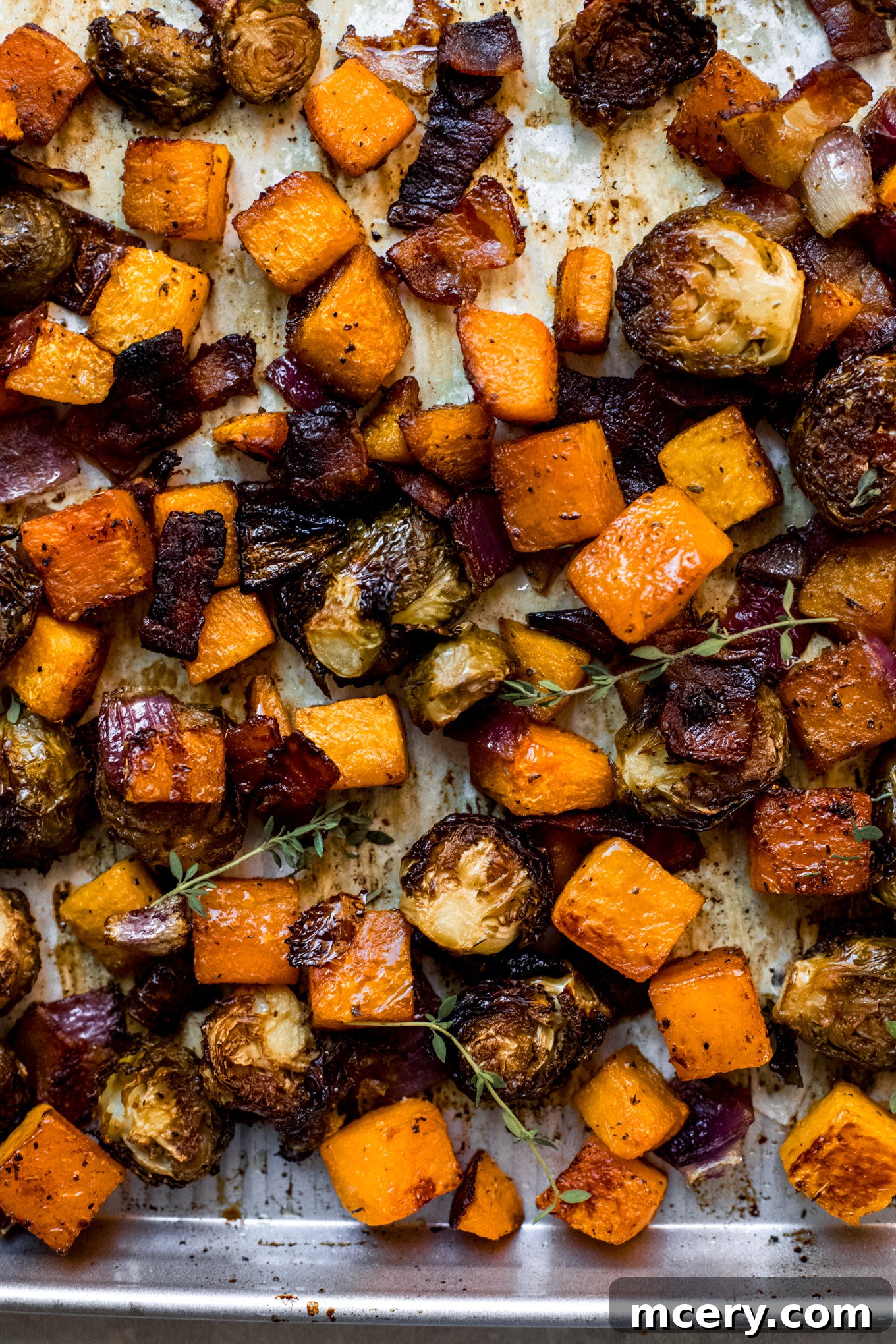 Autumn Roasted Bounty 8 Platter of roasted vegetables, garnished with fresh thyme, ready for serving.