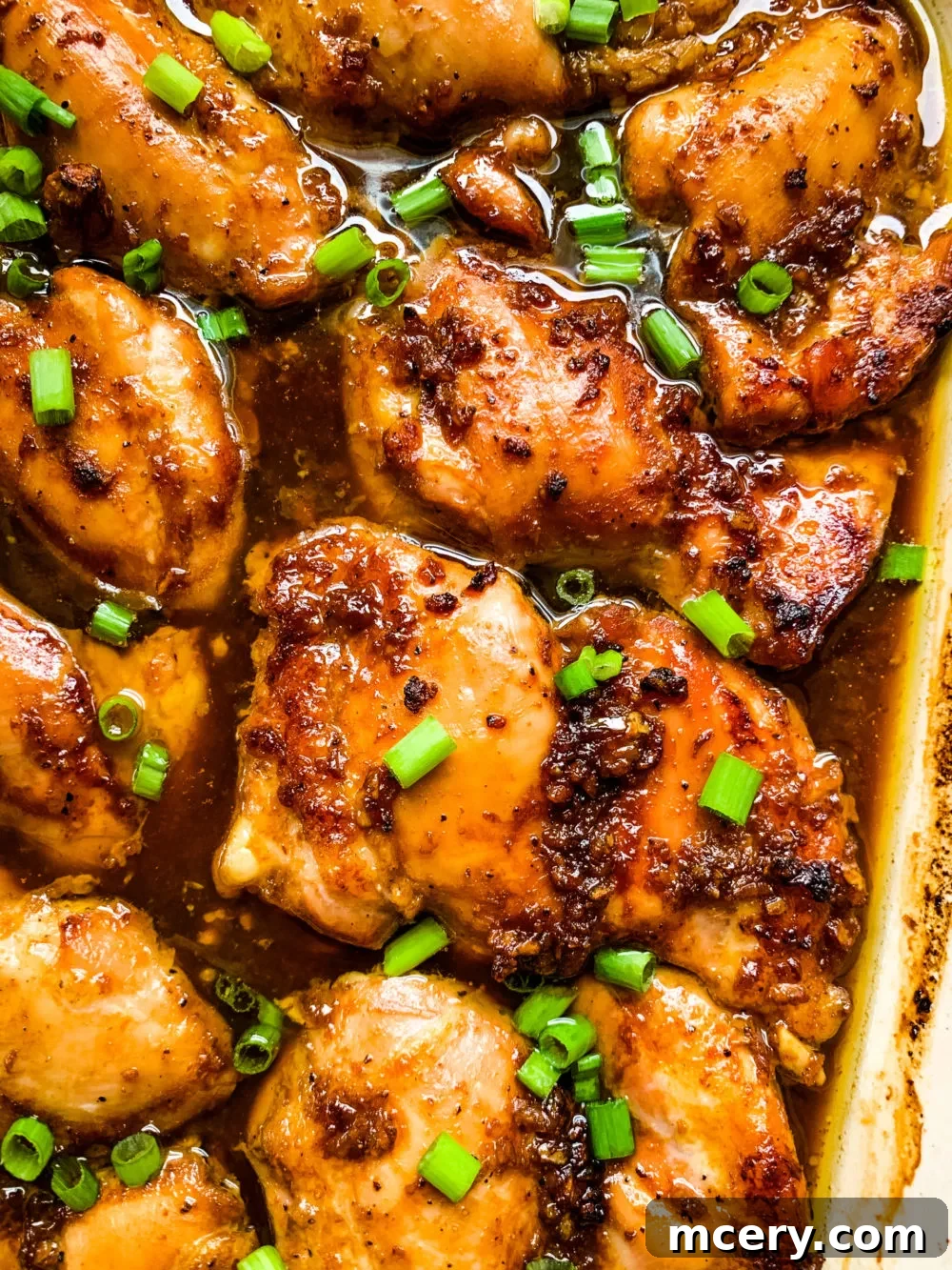 Sticky Garlic Brown Sugar Chicken 6 Garlic Brown Sugar Chicken in a baking dish, garnished.