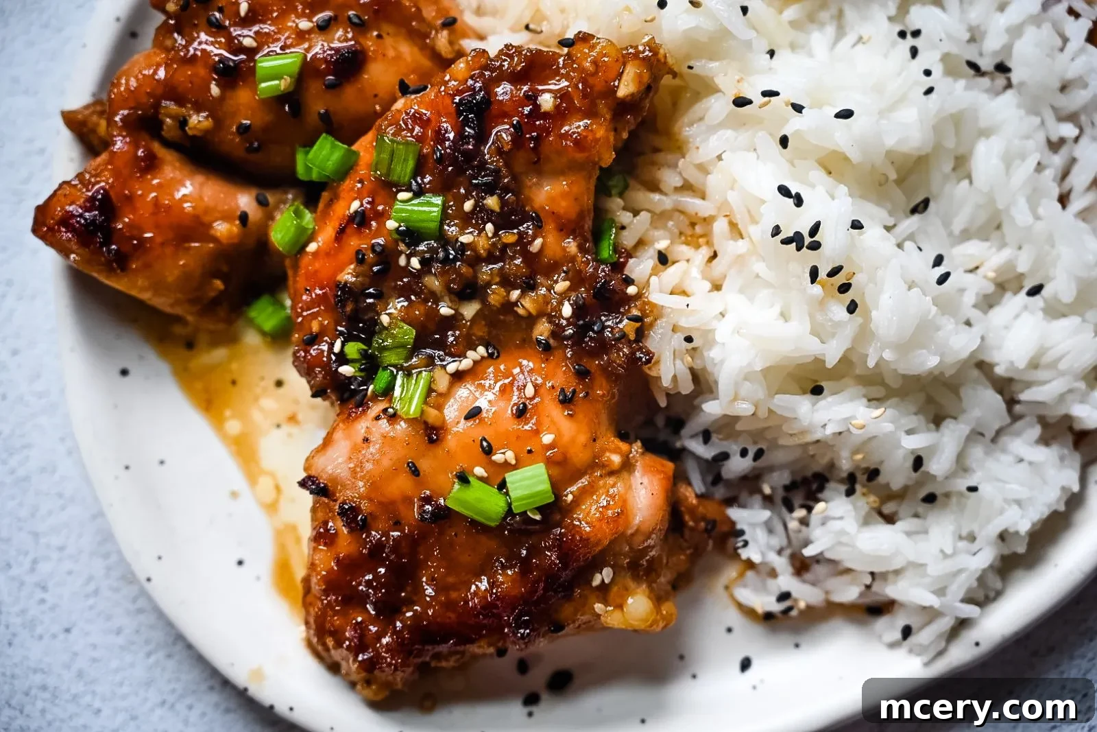 Sticky Garlic Brown Sugar Chicken 7 Close-up of sticky Garlic Brown Sugar Chicken with vibrant green onions.