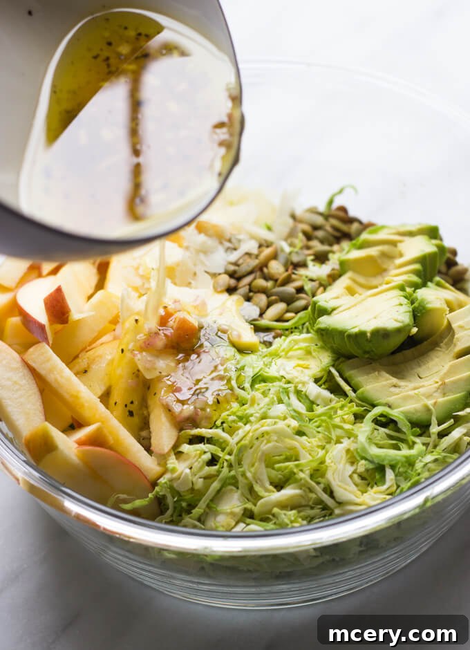 Harvest Apple Brussels Sprout Salad 6 salad vinaigrette over shaved Brussels sprouts salad with apples.
