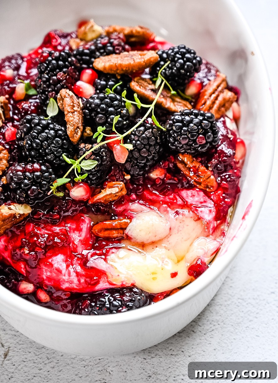 An aesthetic overhead shot of the baked brie, perhaps with a rustic background or serving utensils, emphasizing its inviting nature.