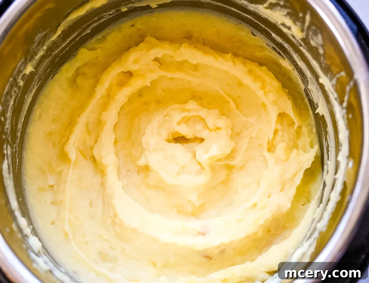 Golden Roasted Garlic Mash 6 A bottle of half and half dairy product, for creamy mashed potatoes.