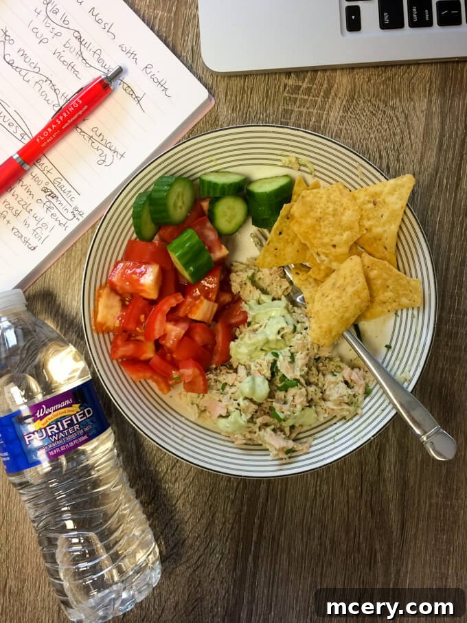 Tuna salad mixed with avocado aioli, served with cucumber, tomatoes, and tortilla chips for a crunchy lunch.