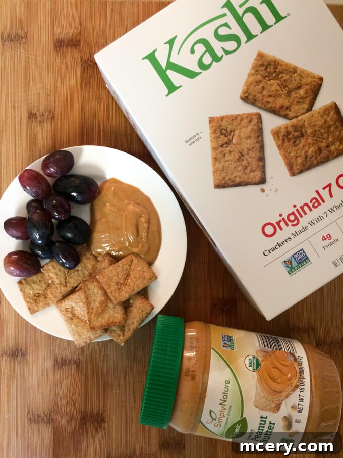 Afternoon snack featuring fresh fruit, nut butter, and lightly sweetened Kashi crackers.