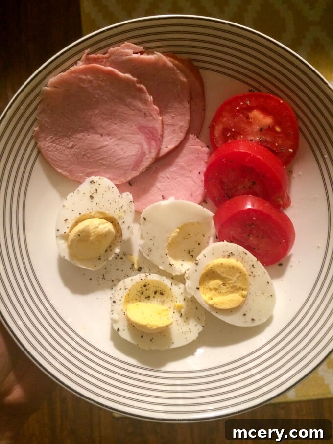 A simple yet satisfying dinner of Russian kielbasa, hard-boiled eggs, and fresh tomatoes.