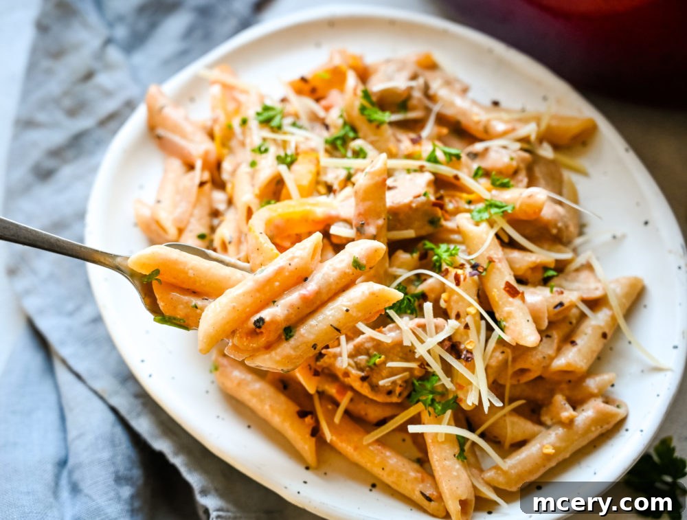 Bold One-Pot Cajun Chicken Pasta 3 Close-up of One-Pot Cajun Chicken Pasta in a skillet, showcasing the rich sauce and ingredients.