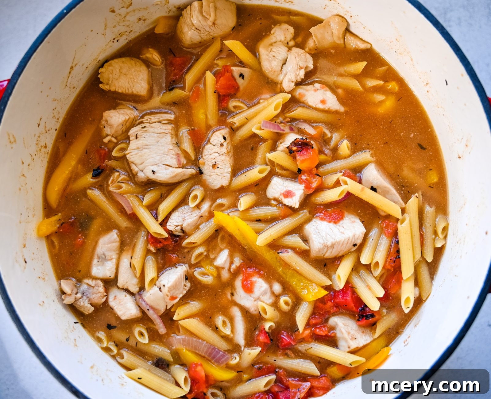 Bold One-Pot Cajun Chicken Pasta 6 Sautéing onions and bell peppers in a pot for the Cajun chicken pasta.
