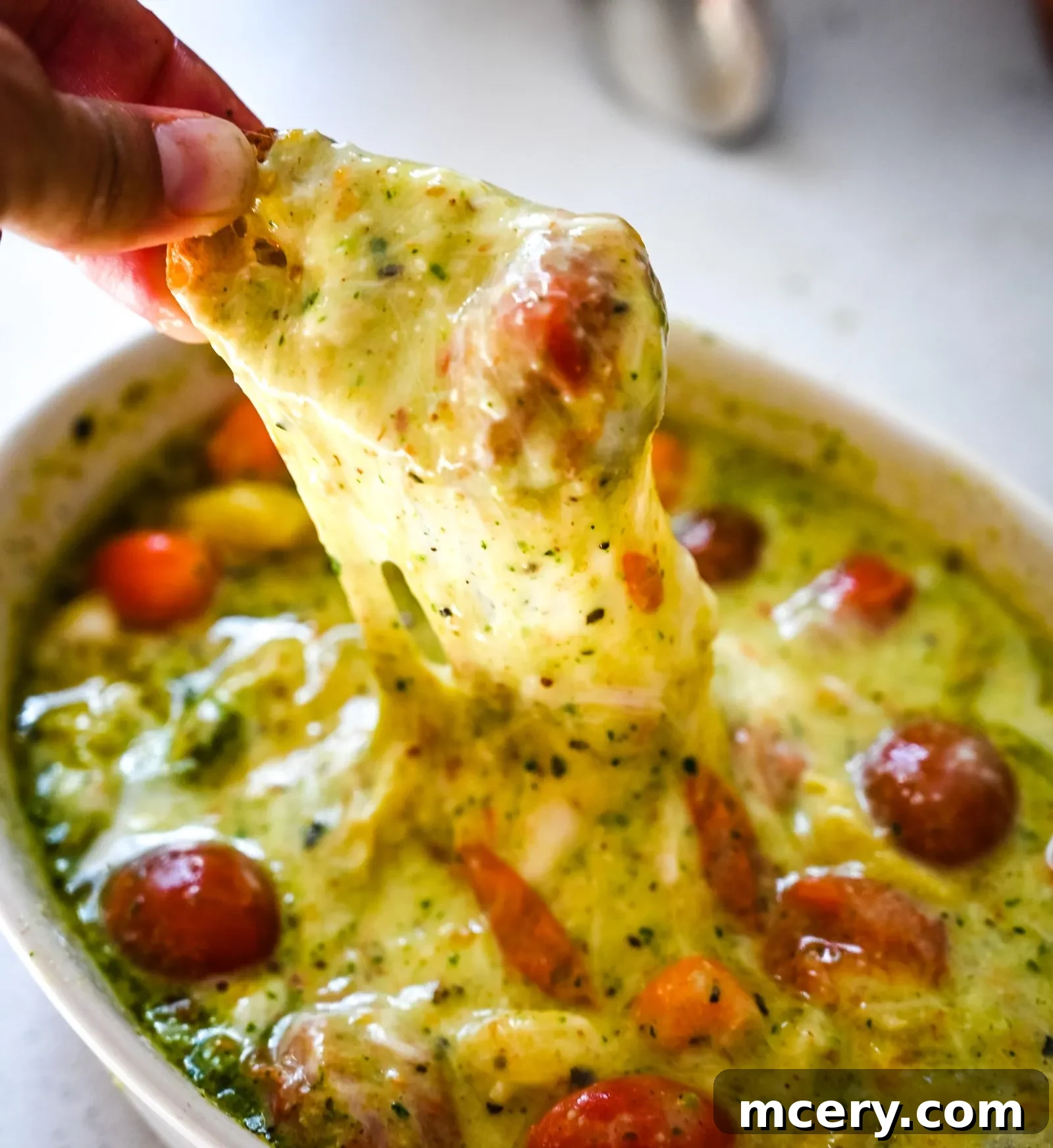 Velvet Burrata with Roasted Tomatoes and Fiery Pesto 4 A bowl of vibrant green pesto next to whole jalapeños and cilantro