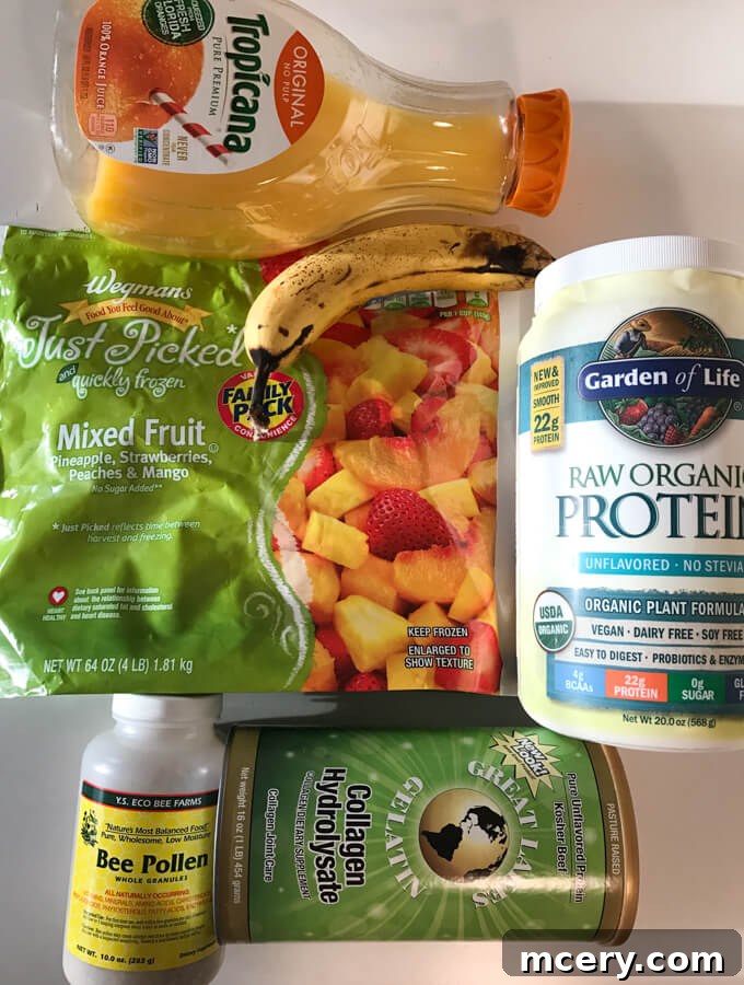 Ingredients for a healthy breakfast smoothie, including protein powder, fruit, collagen, and bee pollen.