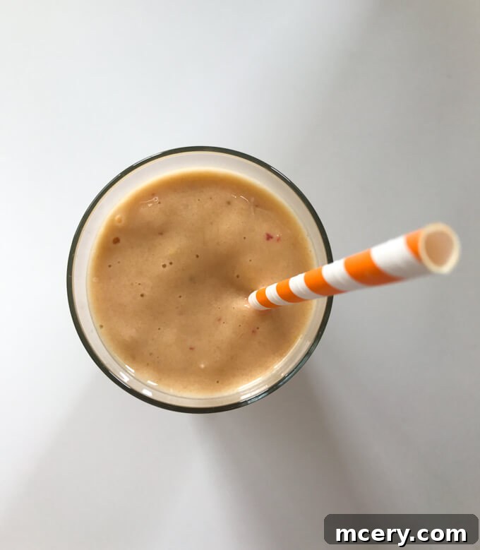 A refreshing and nutritious breakfast smoothie made with mixed fruits, banana, collagen, and bee pollen.