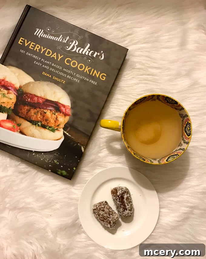 An evening snack of tea and coconut dates, paired with the 'Minimalist Baker’s Everyday Cooking' cookbook.