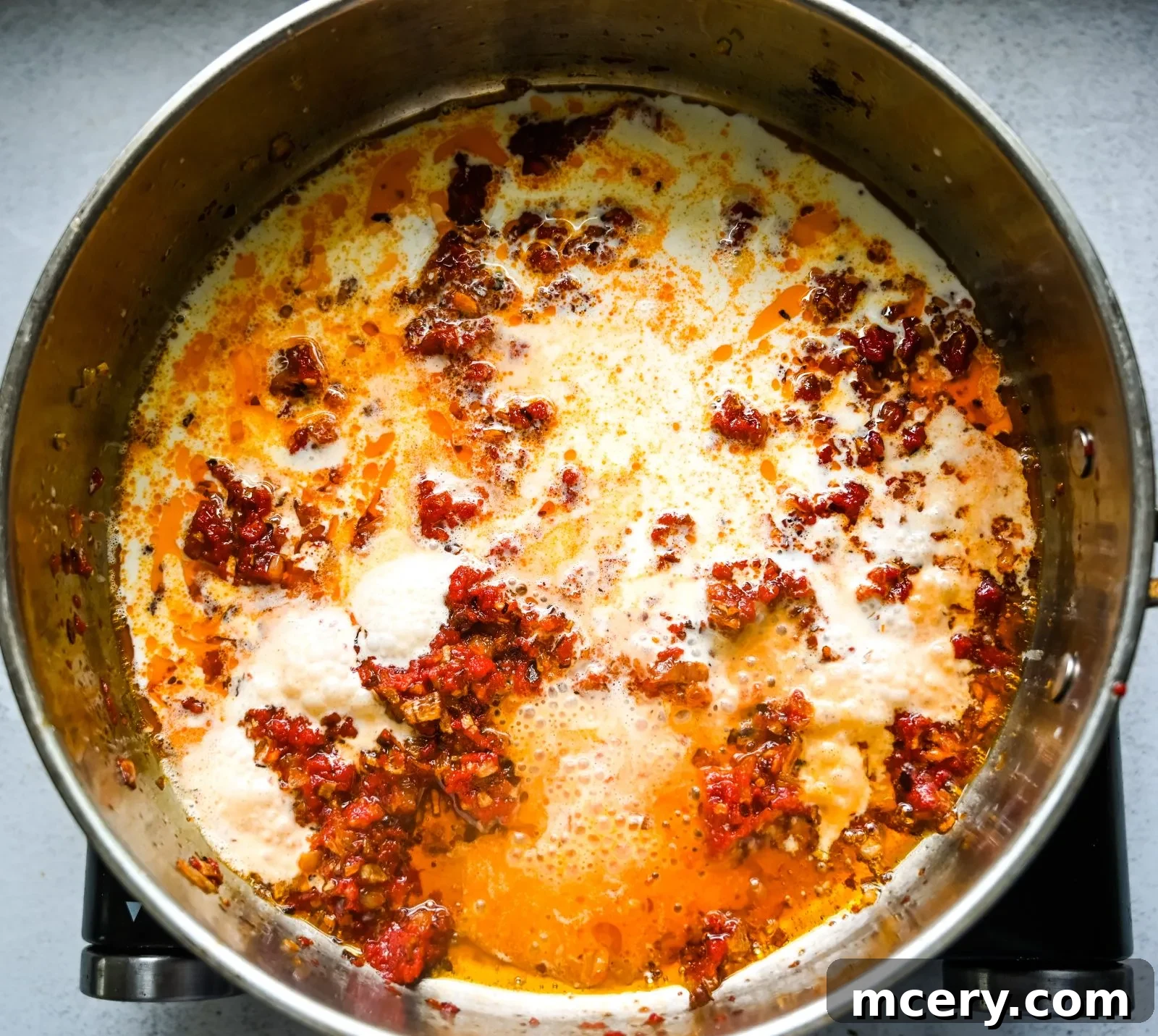 Gigi Hadid's Signature Spicy Vodka Pasta 6 Tomato paste and chili flakes being sautéed to develop deep flavor for Gigi Hadid Pasta.