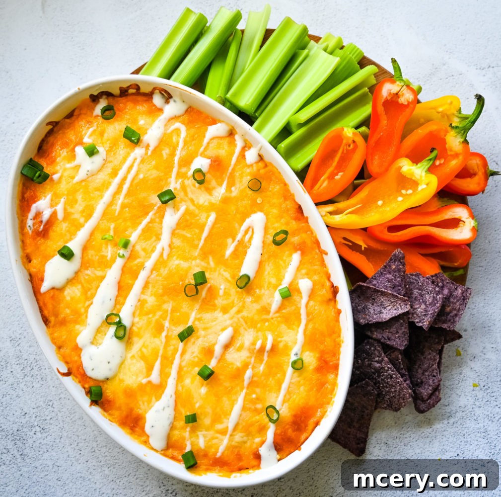 Ultimate Game Day Chicken Dip 3 Close-up of Buffalo Chicken Dip, showing melted cheese and shredded chicken.