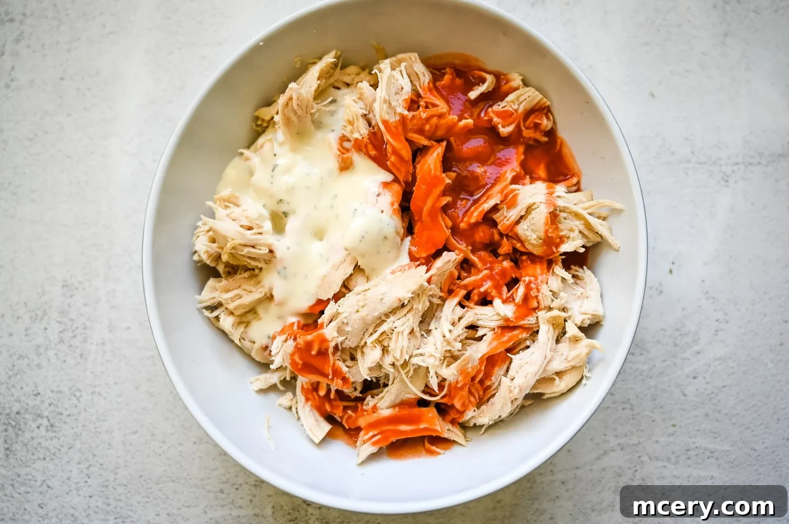Ultimate Game Day Chicken Dip 6 A serving of Buffalo Chicken Dip with dippers arranged beautifully.