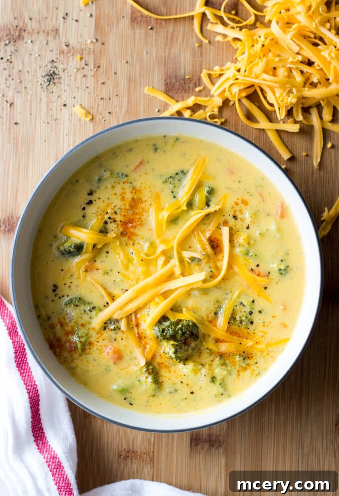 Golden Broccoli Cheddar Bliss 6 An overhead shot of homemade broccoli cheddar soup garnished with fresh herbs, showcasing its rich texture.