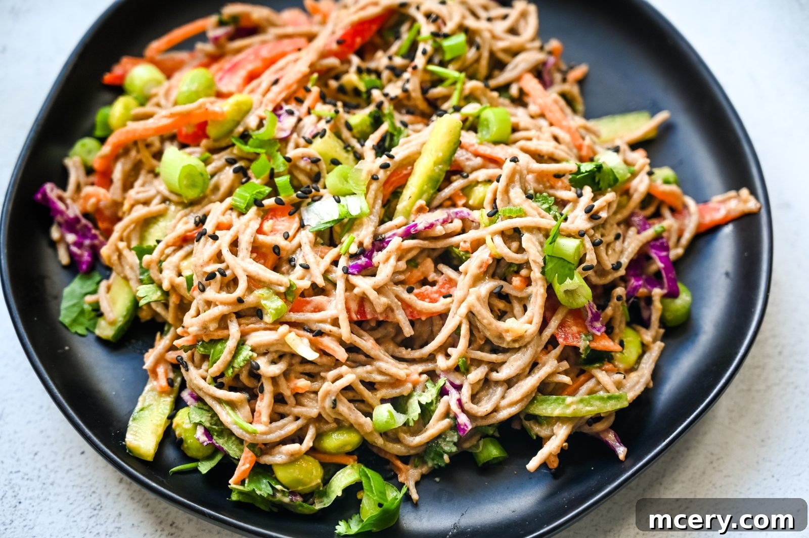 Zesty Peanut Soba Noodle Salad 5 A close-up of Soba Noodle Salad with Peanut Sauce, ready to be served, with emphasis on the vibrant vegetables and the inviting sheen of the peanut dressing.