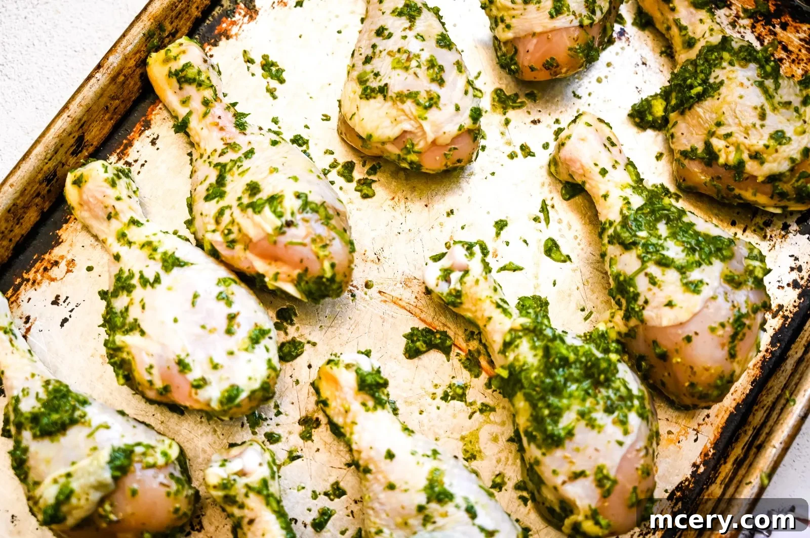Golden Baked Chicken Drumsticks 4 Fresh ingredients for the chimichurri marinade, including basil, parsley, green onions, and lemon.