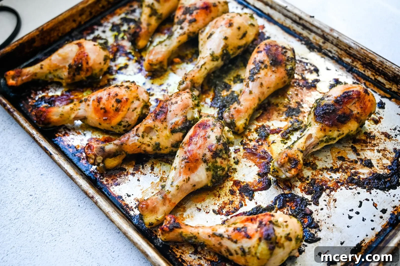 Golden Baked Chicken Drumsticks 5 A food processor filled with chopped herbs and garlic for the marinade.
