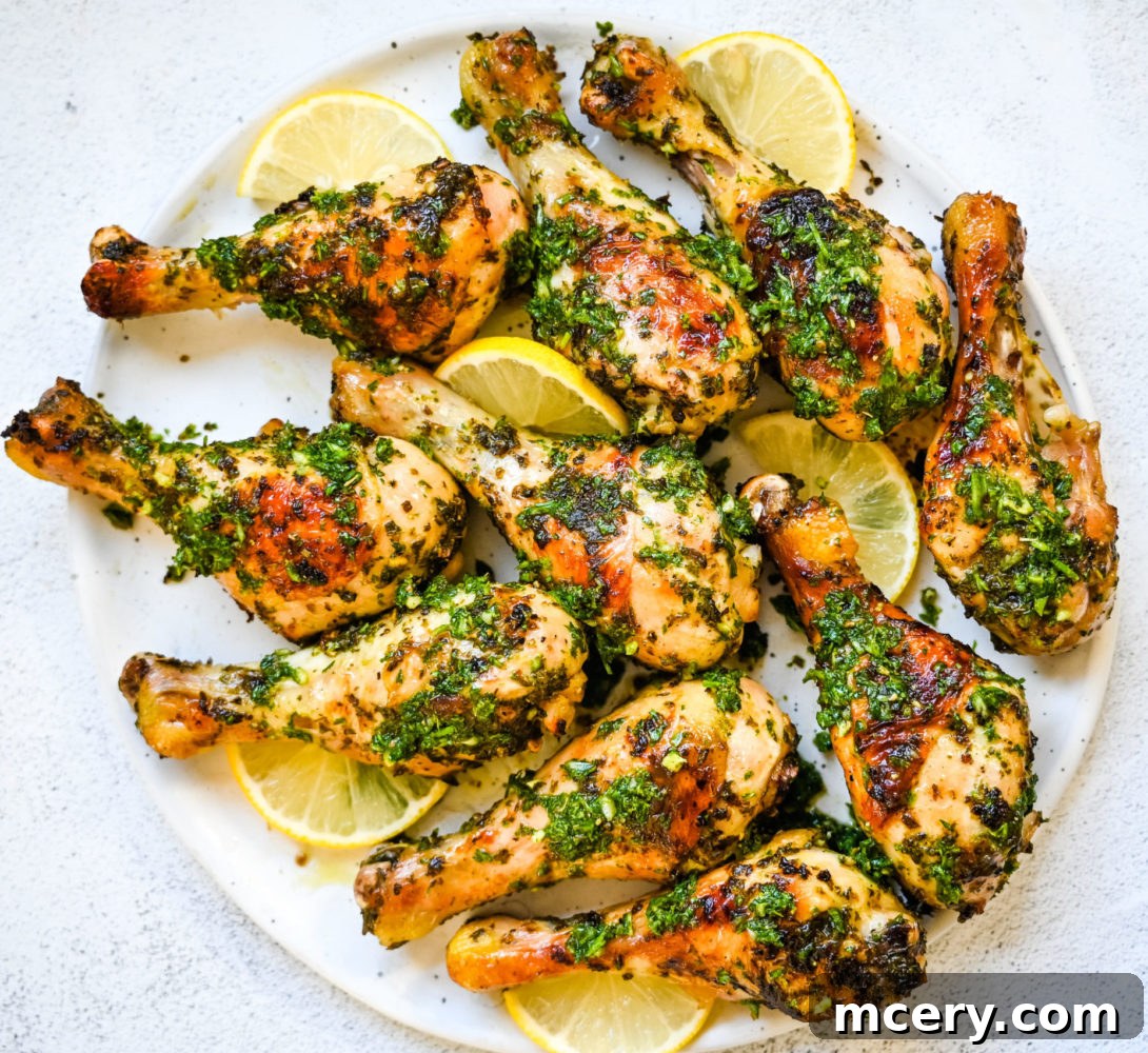 Golden Baked Chicken Drumsticks 6 Chicken drumsticks generously coated in the vibrant green herb marinade, ready for baking.