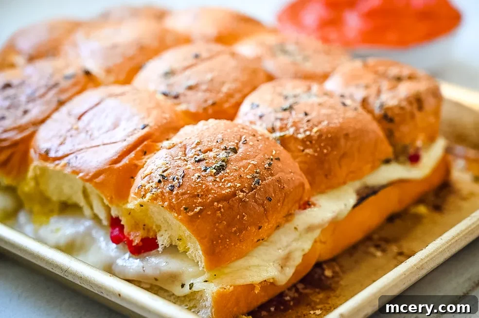 Italian Deli Sliders 4 Freshly prepared Italian Slider ingredients, including Hawaiian rolls, ham, pepperoni, and cheese.