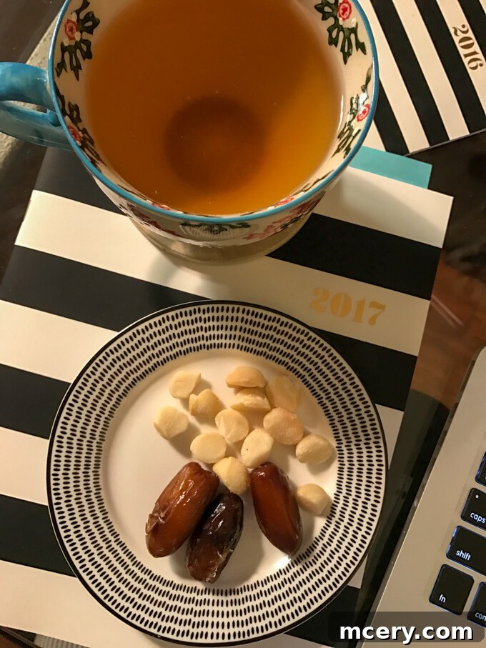 Soothing Peach Tranquility tea with a side of macadamia nuts and dates, a perfect evening snack for relaxation.