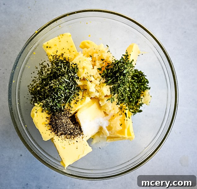 Skip the Brine! Your Easiest, Juiciest Thanksgiving Turkey Ever 5 A clear glass bowl contains chunks of butter, sprinkled with finely chopped herbs, minced garlic, black pepper, and a pinch of salt. The ingredients are ready to be mixed, set against a plain light-colored background.