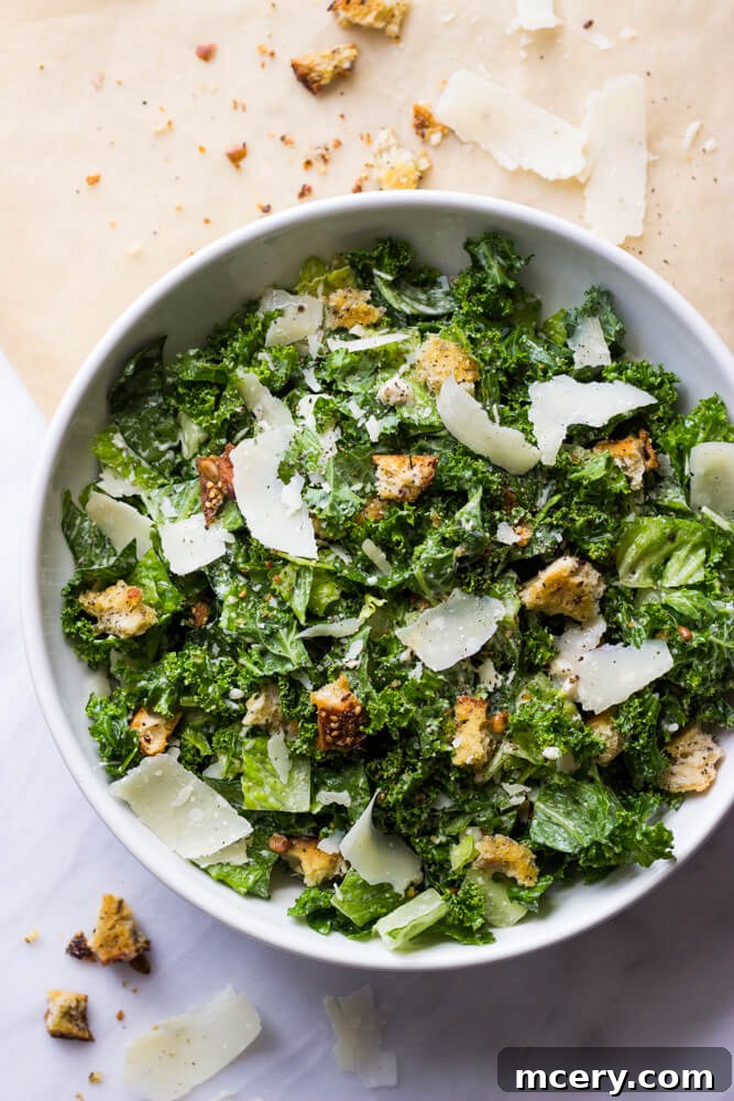 A vibrant bowl of Kale Caesar Salad, showcasing crisp greens and a creamy dressing.
