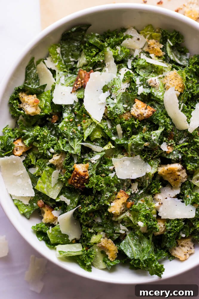 A beautifully presented serving of Kale Caesar Salad in a modern bowl.
