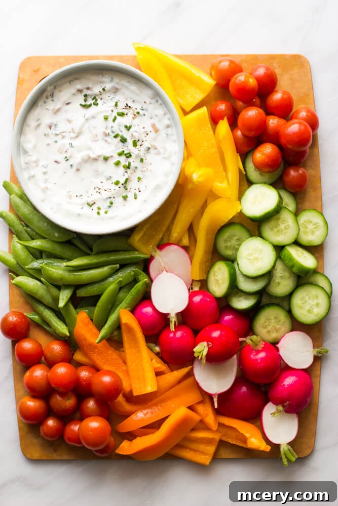 Tangy Greek Yogurt Onion Dip 2 Creamy Greek yogurt onion dip with fresh chives, ready to be served with crackers.