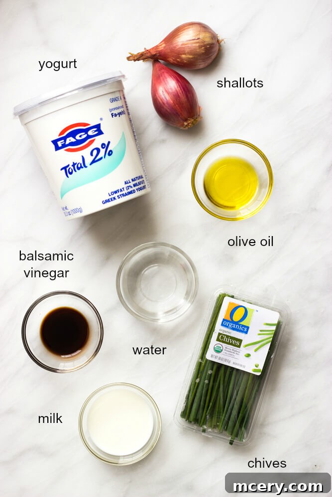 Tangy Greek Yogurt Onion Dip 4 Arrangement of fresh ingredients including shallots, Greek yogurt, chives, and balsamic vinegar on a wooden board.