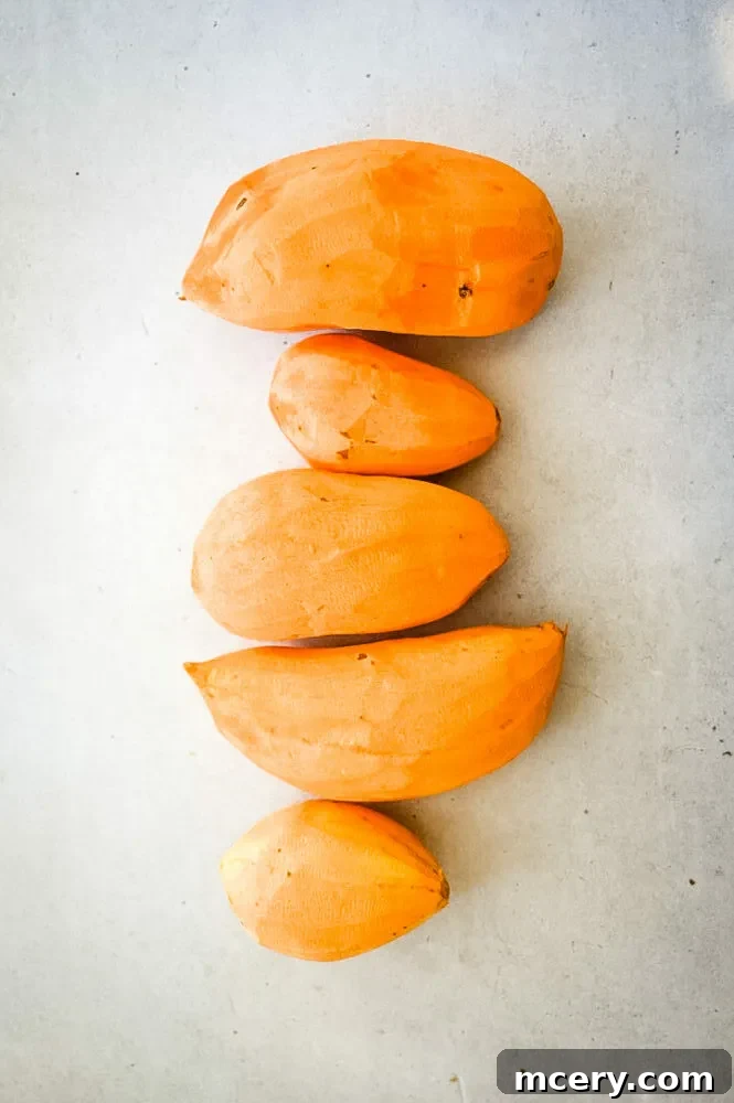 Decadent Candied Sweet Potatoes 4 A close-up of a serving spoon scooping out a portion of Candied Sweet Potatoes from a baking dish, highlighting the tender texture and rich glaze.